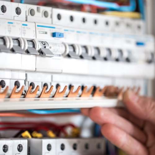 man-electrical-technician-working-switchboard-with-fuses-installation-connection-electrical-equipment-close-up (1)